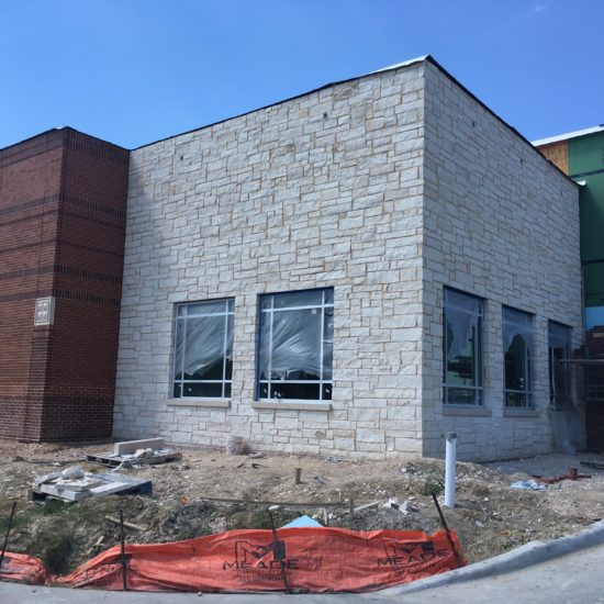 Stone veneer and exterior finish on the shell at Care Now Rockwall