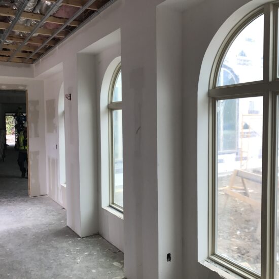Finished gypsum wallboard with arched window returns at Church of the Apostles